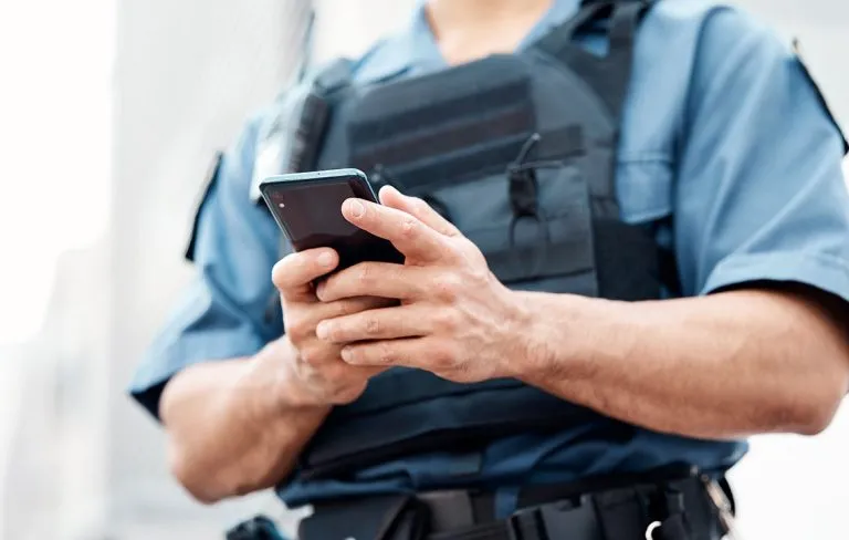 security guard with a mobile device in hand