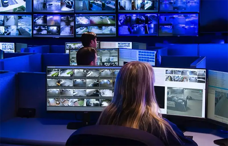 security guards monitoring camera feeds