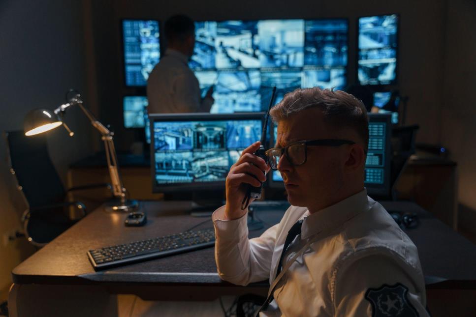 security guard sitting at a camera monitoring station