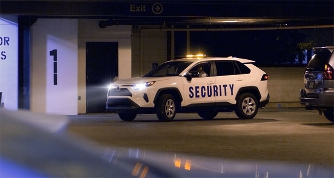 security officer in security marked vehicle at their post