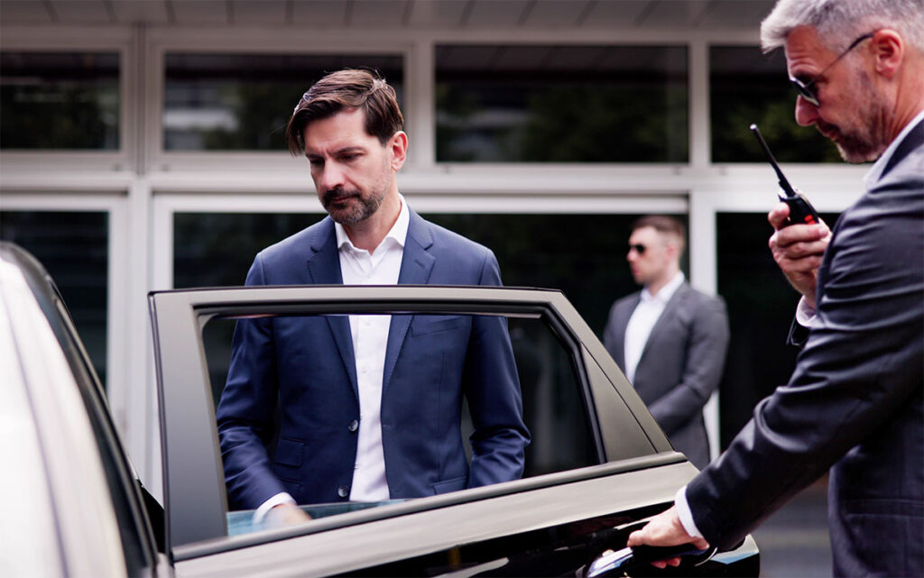 executive protection detail opening a car door for a client