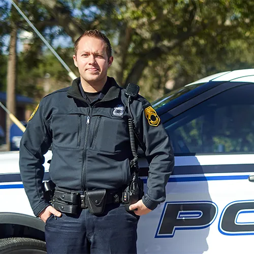 police officer standing in front of police vehicle
