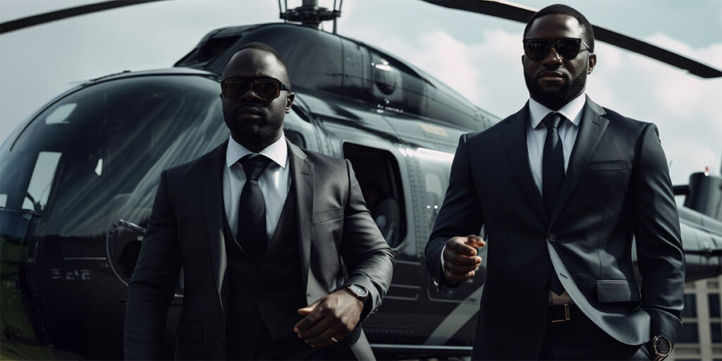 Two professional executive protection agents in suits and sunglasses walking away from a black helicopter.