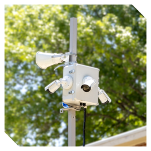 Mobile security unit with mounted cameras and floodlights installed on a pole