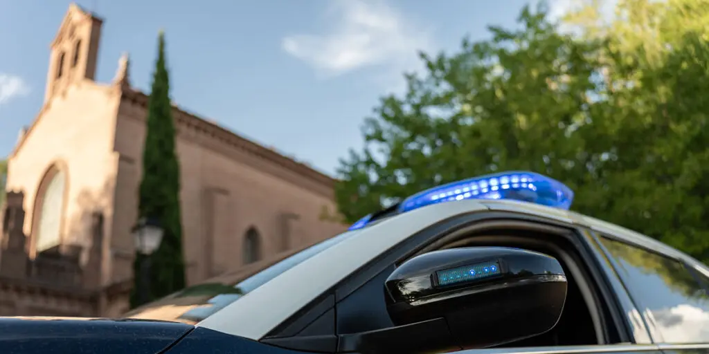 Image of a police car outside of a church