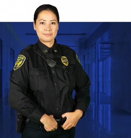 police-officer-female-blue-bg police officer standing ready blue background