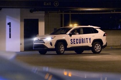 security officer in security marked vehicle at their post